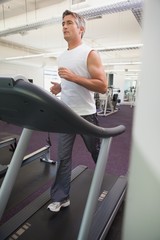 Fit man working out on treadmill