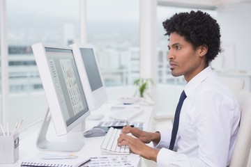 Handsome photo editor working at desk