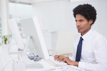 Handsome photo editor working at desk