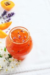 Homemade delicious apricot jam on a white background