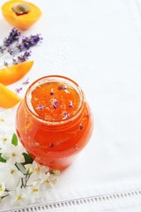 Homemade delicious apricot jam on a white background