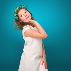 Girl smiling and looking at the camera in a white dress