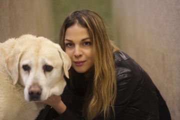 portrait of blonde girl with a labrador