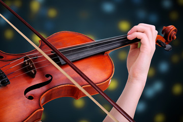 Beautiful young girl with classical violin on bright background