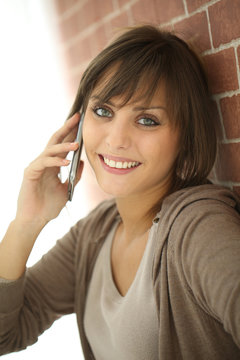 Closeup of young woman talking on mobile phone