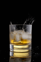 Whisky splash against black background