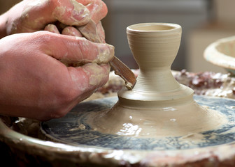 hands of a potter, creating an earthen jar