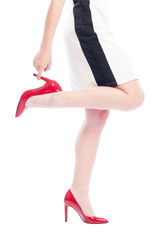 Woman with red shoes grabbing one leg heel.
