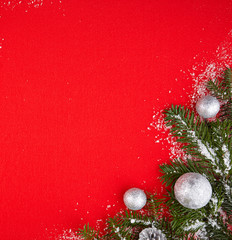 Gifts and Christmas tree branch in the snow and red background,