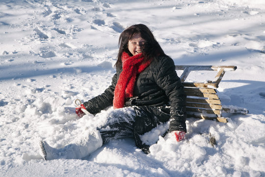 Woman playing and enjoying with sledges