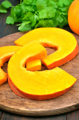 Fresh pumpkin slices on cutting board
