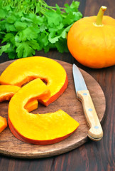Slices of raw pumpkin on cutting board