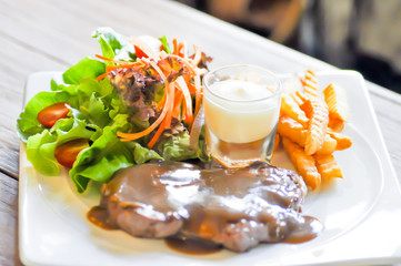 pork steak, French fries  and salad