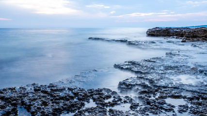 Rocky seashore and calm blue ocean