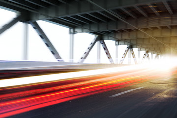 Vehicle light trails on a modern bridge.