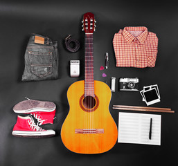 Fototapeta premium Music equipment, clothes and footwear on black background