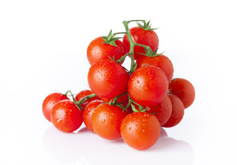 Red tomatoes with drops isolated on white