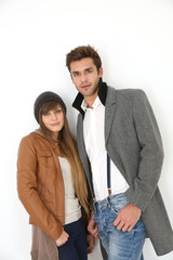 Trendy couple of lovers standing on white background