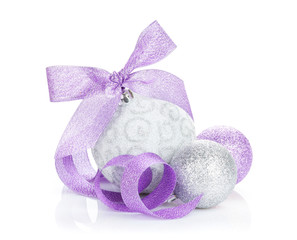 Fototapeta na wymiar Christmas baubles and purple ribbon
