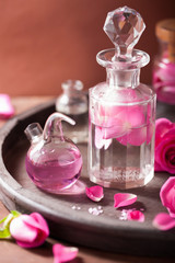 alchemy and aromatherapy set with rose flowers and flasks