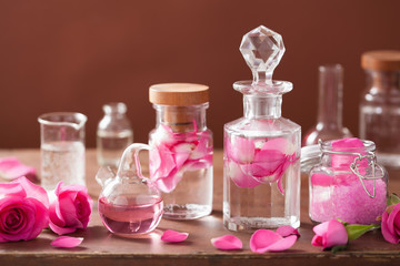 alchemy and aromatherapy set with rose flowers and flasks