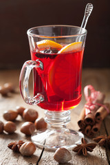 glass of mulled wine with orange and spices, winter drink