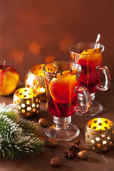glass of mulled wine with orange and spices, christmas decoratio