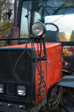 Part of red tractor on the street.