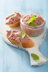 healthy chicken liver pate with sage in jar and on bread