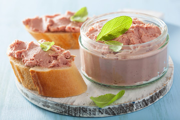 healthy chicken liver pate with sage in jar and on bread