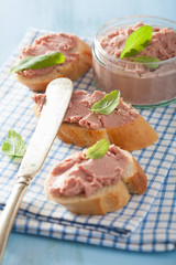 healthy chicken liver pate with sage in jar and on bread