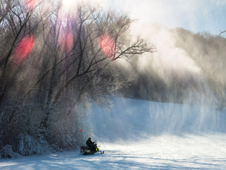 Fototapeta premium Ski patrol on snowmobile at a ski-field