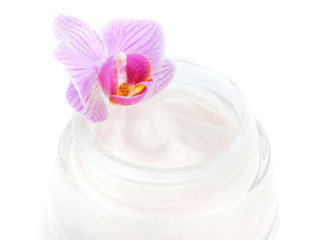 Face cream and beautiful orchid flower on white background