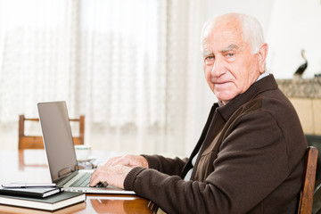 Fototapeta na wymiar Senior working with Laptop, old man retired