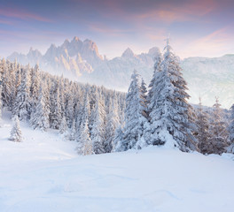 Colorful winter sunset in the foggy mountains.