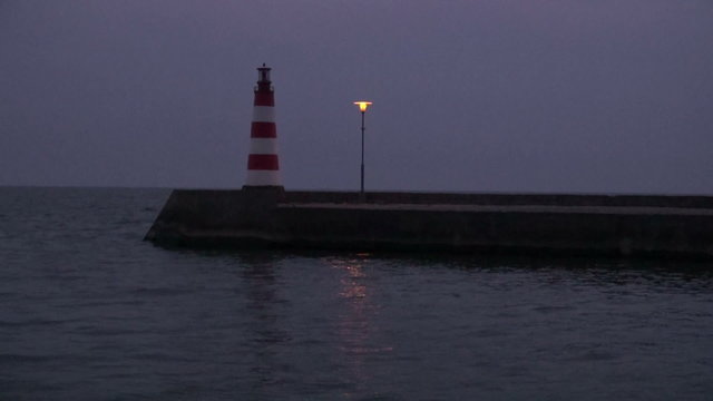 sea lighthouse and pier at night
