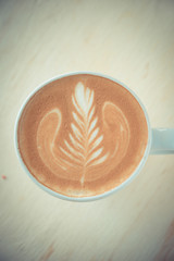 cup of coffee in coffee shop vintage color tone
