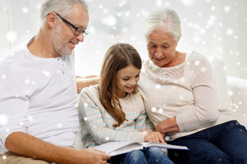 smiling family with book at home