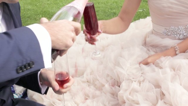 Pouring red wine on wedding dress