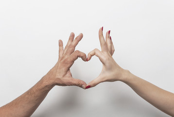 Couple hands making heart gesture
