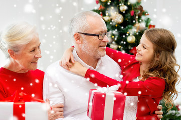 smiling family with gifts at home