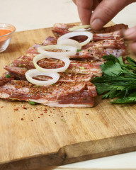 hands preparing meat for barbecue