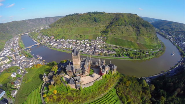 Flying above old century castle, small village river vine hills