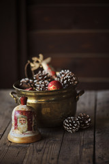 Obraz na płótnie Canvas Christmas decoupage bell, pine cones and decorations