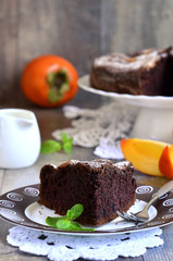 Piece of a chocolate cake with persimmon.