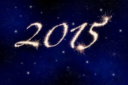 2015 in fireworks against the night sky with stars.