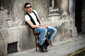 Attractive young man relaxing in urban background