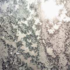 Snowflakes and ice on frozen window