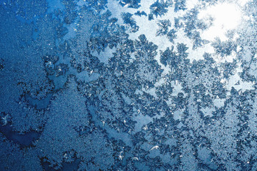 Snowflakes and ice on frozen window