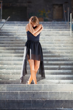 Contemporary bellerina dancing on urban staircase